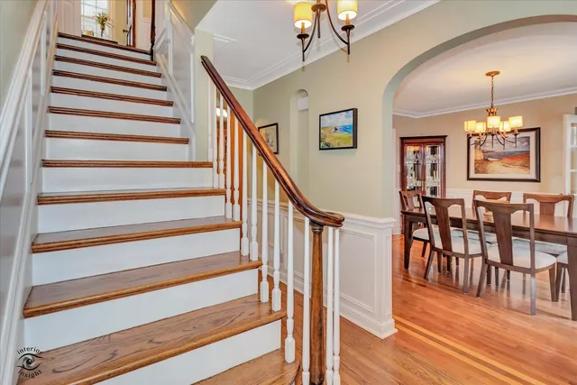 a view of a dining room with wooden floor and stairs