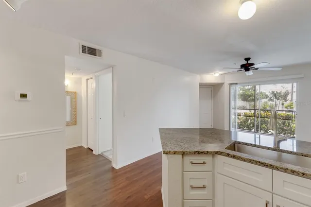a kitchen with granite countertop a sink and a window