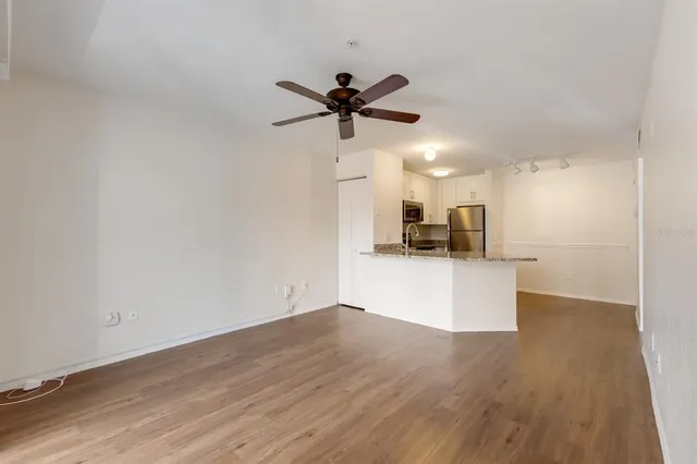 a view of a kitchen with a sink and a refrigerator