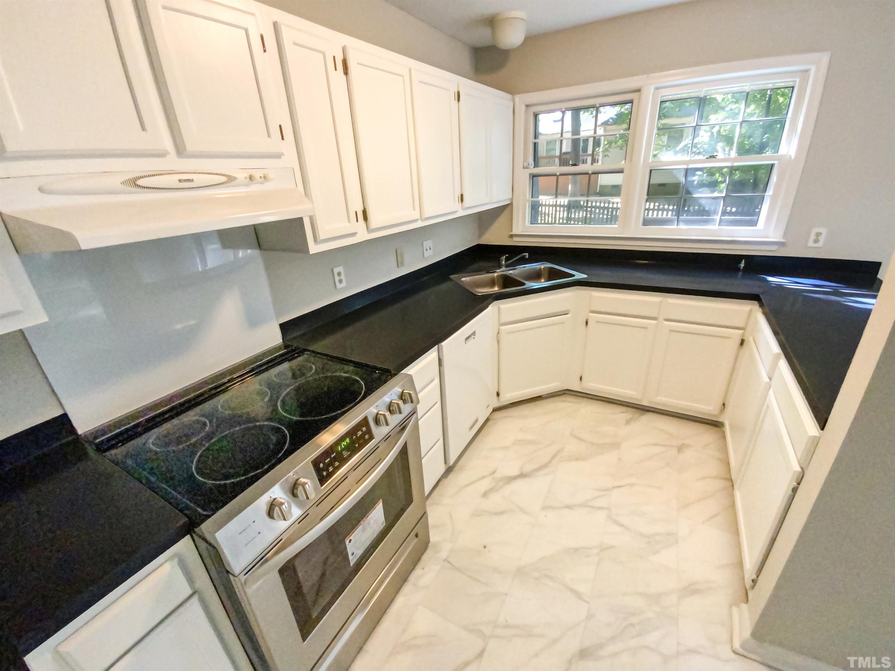 11817 North Exeter Way Raleigh, NC 27613 - Photo 4 of 17 a view of a kitchen with a sink and windows