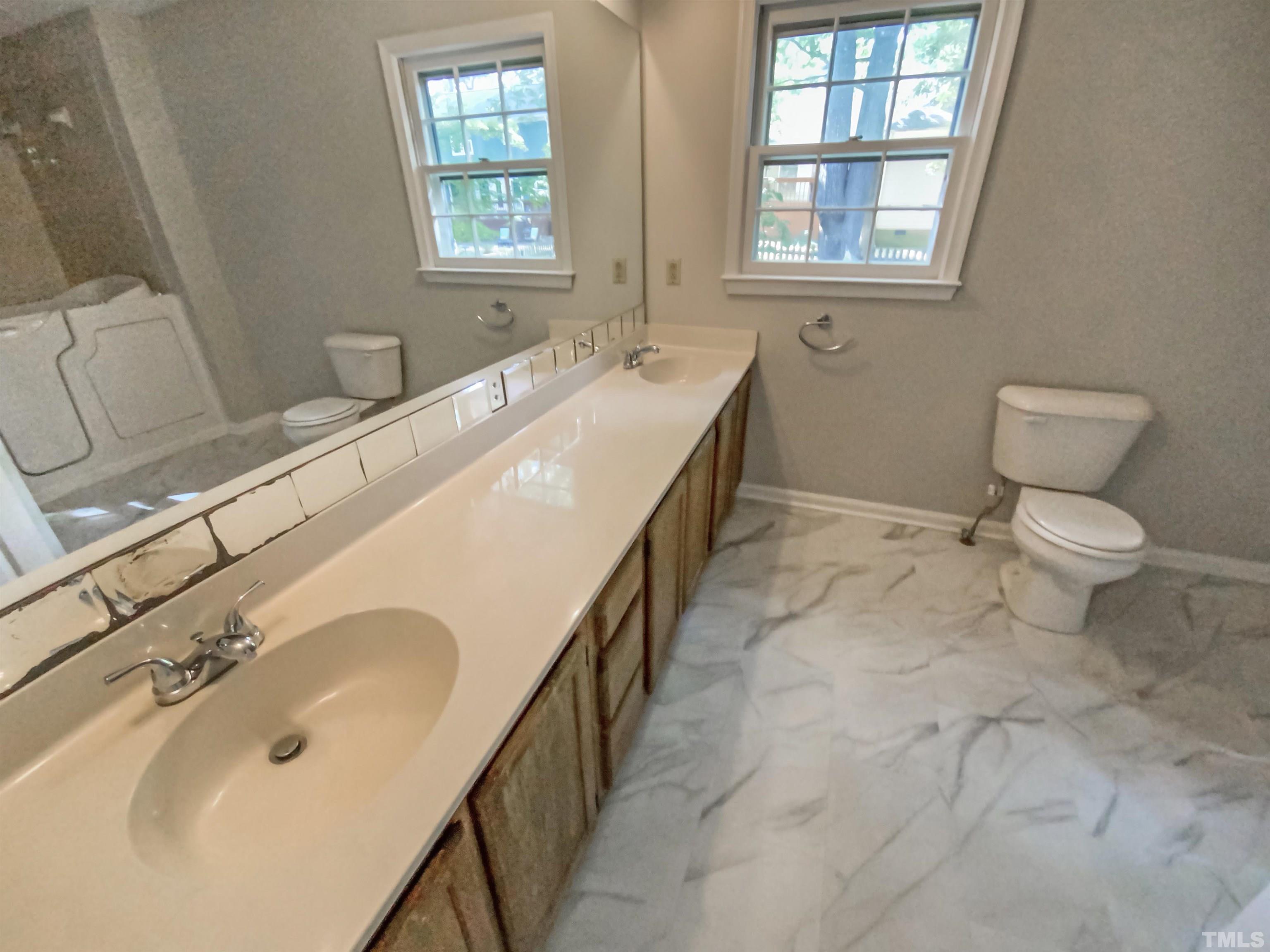 11817 North Exeter Way Raleigh, NC 27613 - Photo 6 of 17 a bathroom with a sink and a toilet