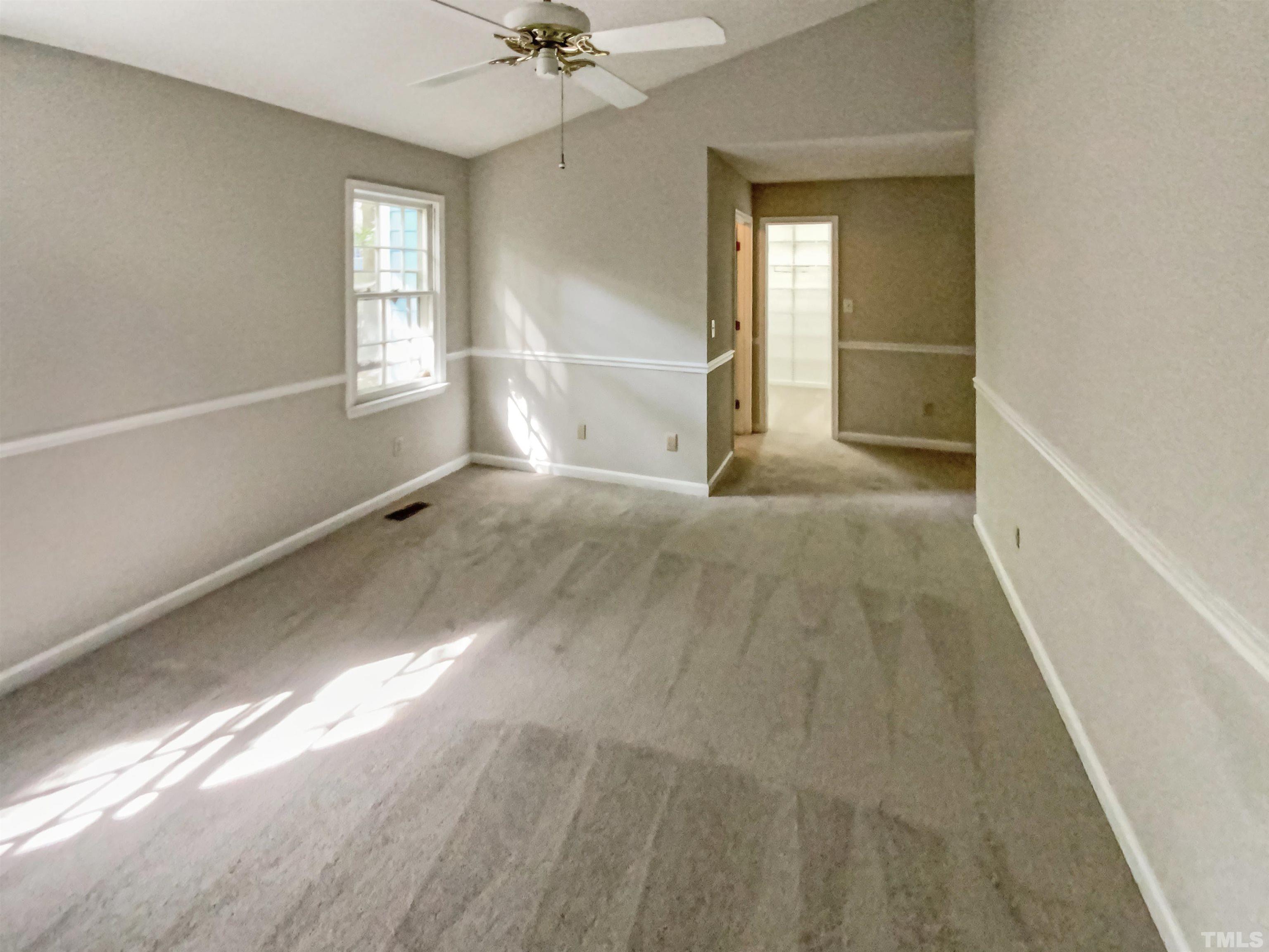 11817 North Exeter Way Raleigh, NC 27613 - Photo 9 of 17 a view of a livingroom with wooden floor and a window