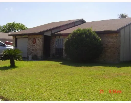 a view of yellow house with a yard