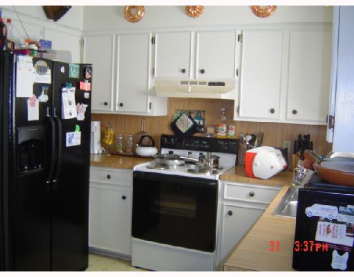 2821 Ransom Island Drive Corpus Christi, TX 78418 - Photo 3 of 6 a kitchen with stainless steel appliances granite countertop a stove a sink and a refrigerator