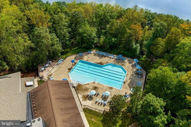 an aerial view of a house with a yard and trees