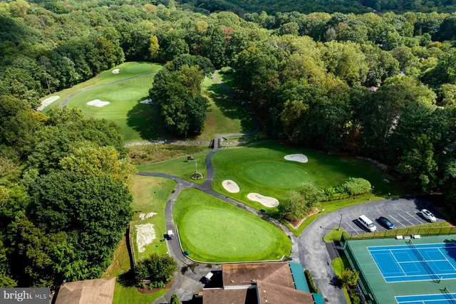 an aerial view of a golf course with swimming pool