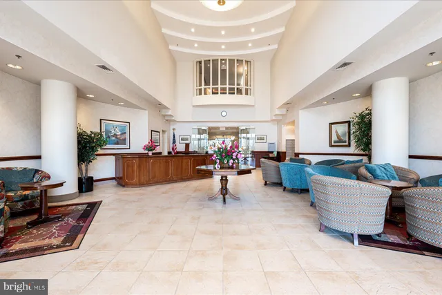 a living room with furniture and a dining table