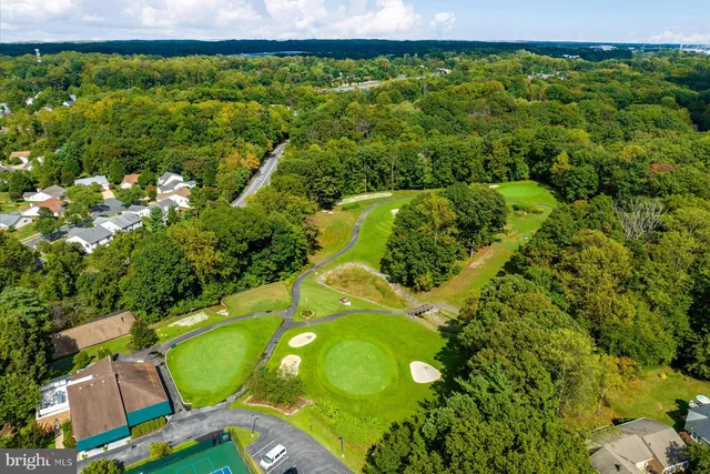 a view of a swimming pool with lawn chairs