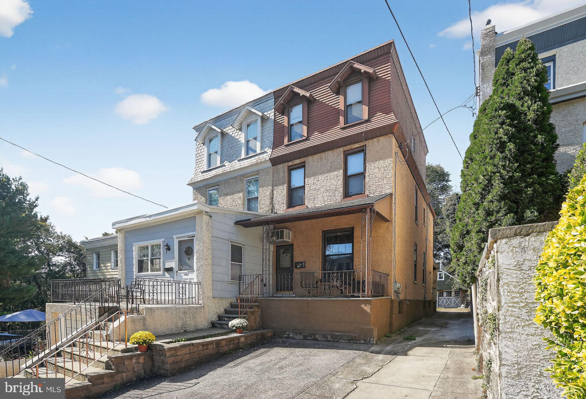 a front view of a house with swimming pool and sitting area
