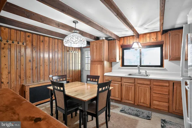 a view of a dining room with furniture and window