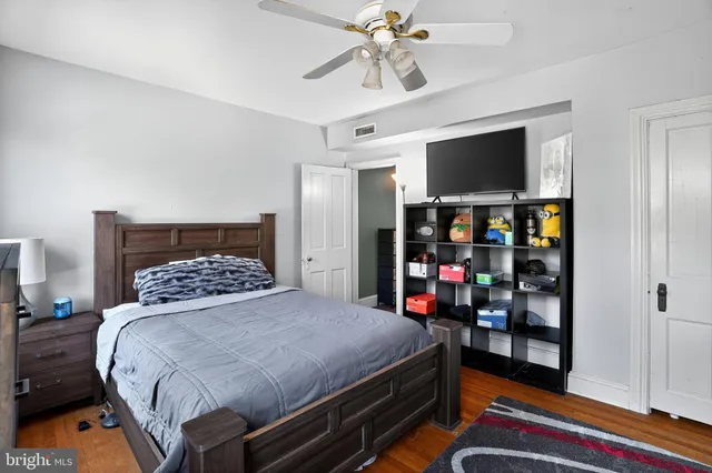 a bedroom with a bed and a large window