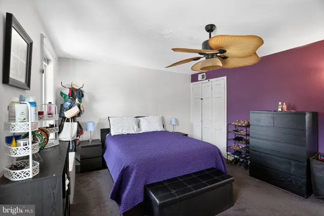 a bed room with a bed and a chair