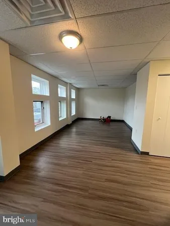 a view of a livingroom with an empty space and a window