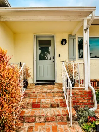a house view with a bench