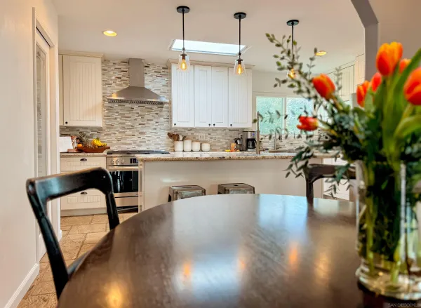 a kitchen with a sink refrigerator and cabinets