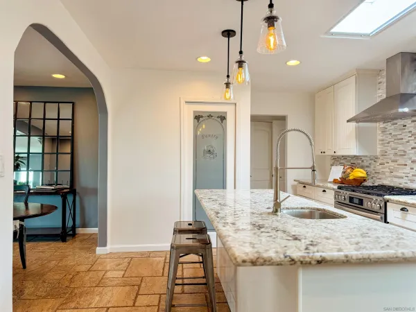 a kitchen with stainless steel appliances a refrigerator sink and cabinets