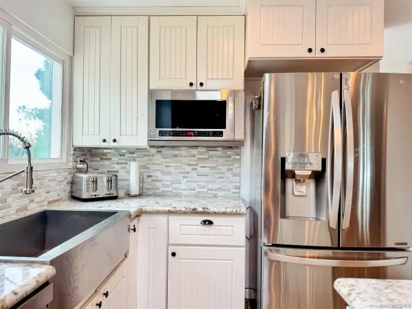 a stove top oven sitting inside of a kitchen