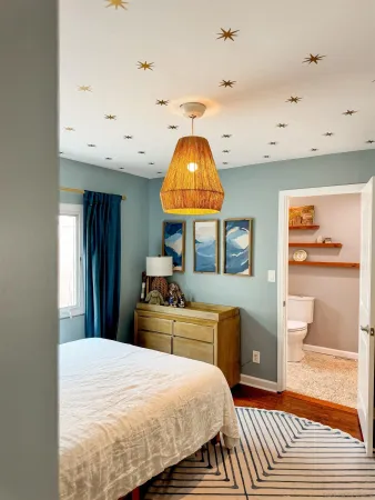 a bedroom with a bed and a view of bathroom
