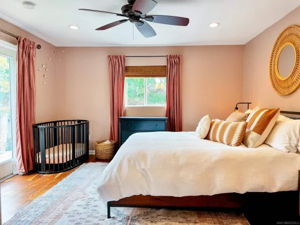 a bedroom with a bed and wooden floor