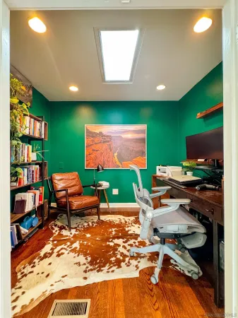 a room with furniture pool table and screen