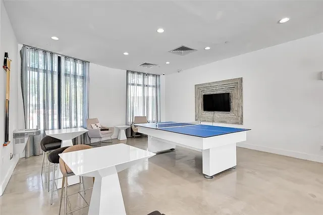 a living room with stainless steel appliances kitchen island granite countertop furniture and a view of living room