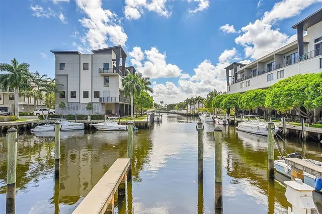 a view of residential houses with outdoor space and lake view