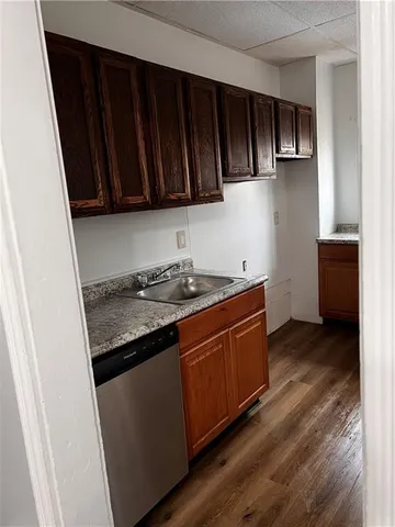 a kitchen with granite countertop stainless steel appliances a stove sink and cabinets