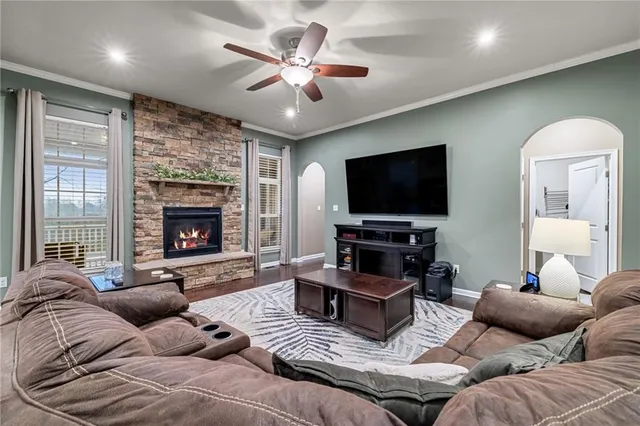 a living room with furniture ceiling fan and a fireplace