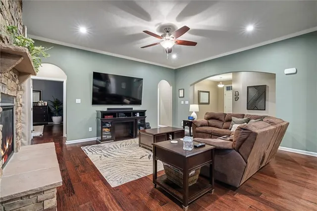a living room with fireplace furniture and a flat screen tv