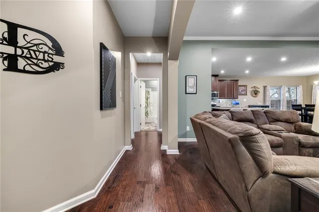 a living room with couches and painting on the wall
