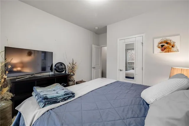 a bedroom with a bed and dresser