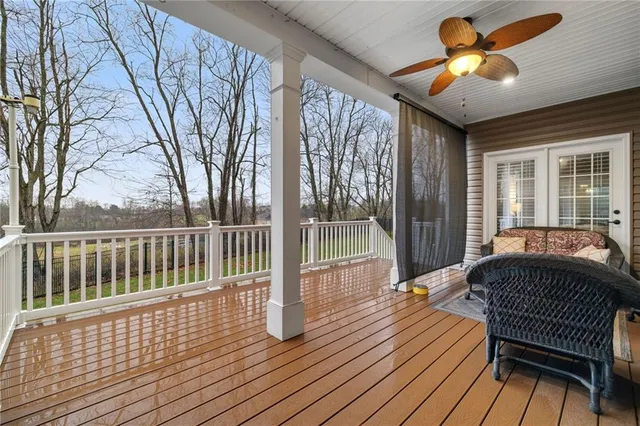 a balcony with wooden floor and furniture