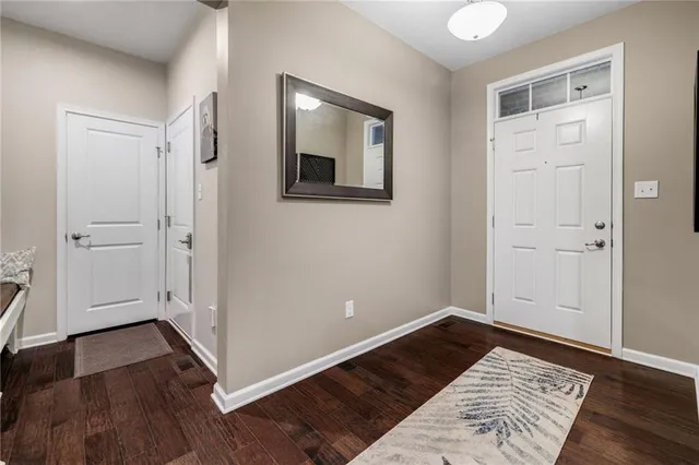 an empty room with wooden floor and closet
