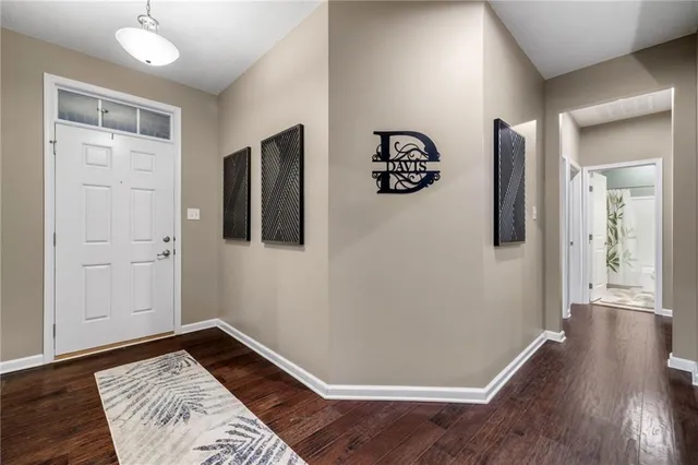 a view of a room with wooden floor and hallway