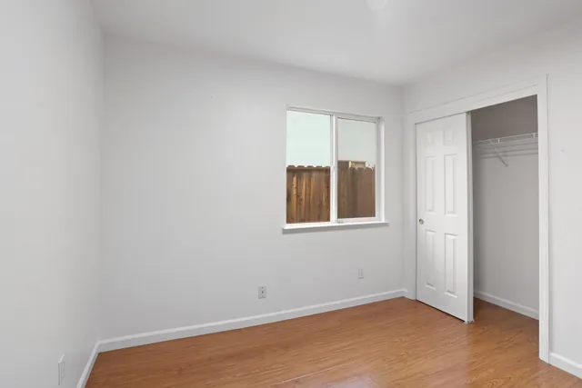 a view of a room with wooden floor and closet