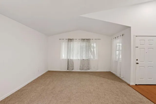 an empty room with a empty space and windows