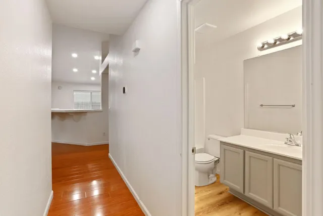 a view of an empty room with wooden floor