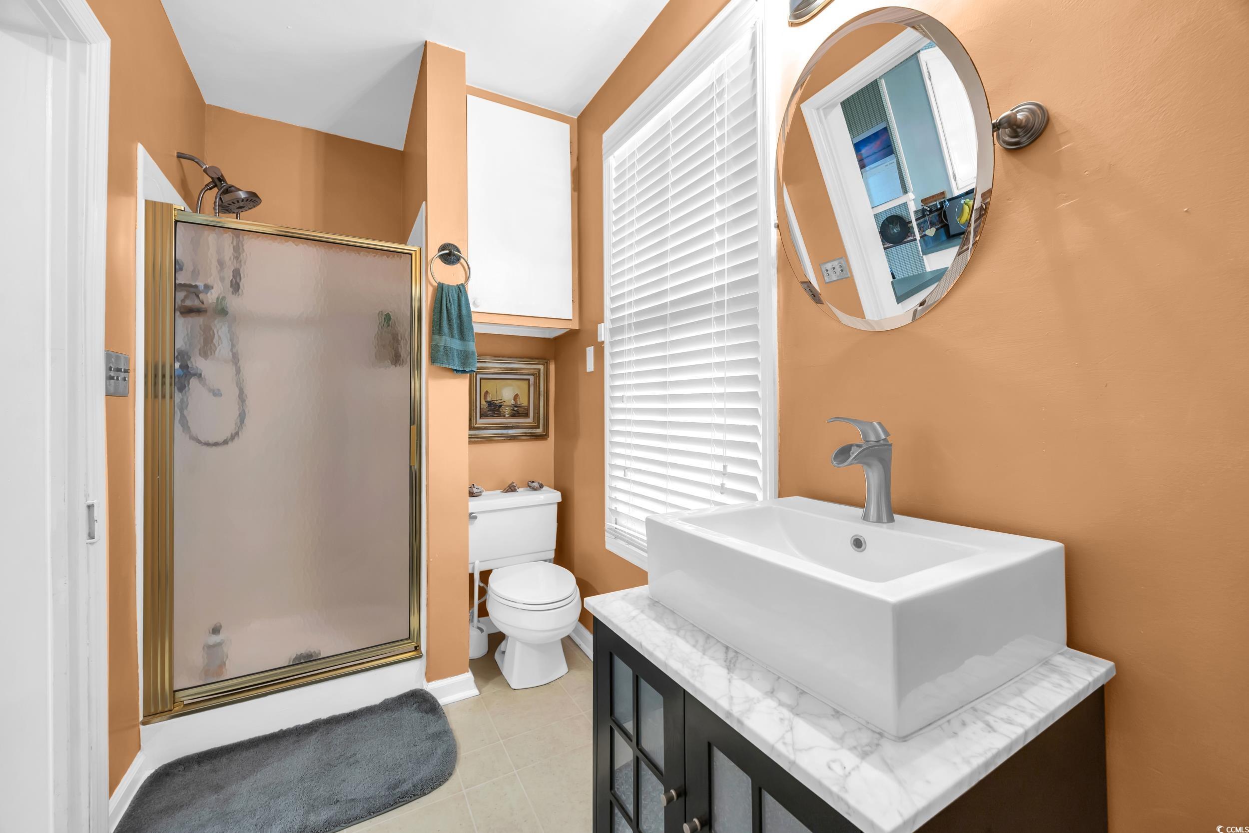 209 Cannon Street Georgetown, SC 29440 - Photo 17 of 34 Full bathroom featuring a shower stall, vanity, and tile patterned floors