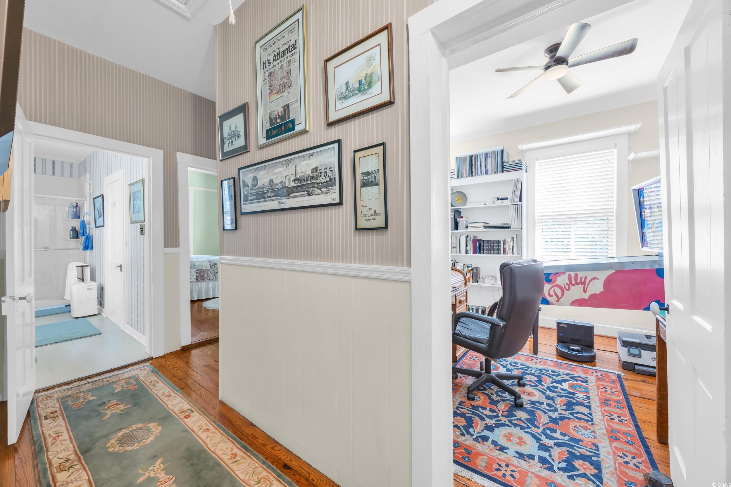 209 Cannon Street Georgetown, SC 29440 - Photo 19 of 34 Hallway featuring wainscoting, hardwood / wood-style flooring, wallpapered walls, and an office area