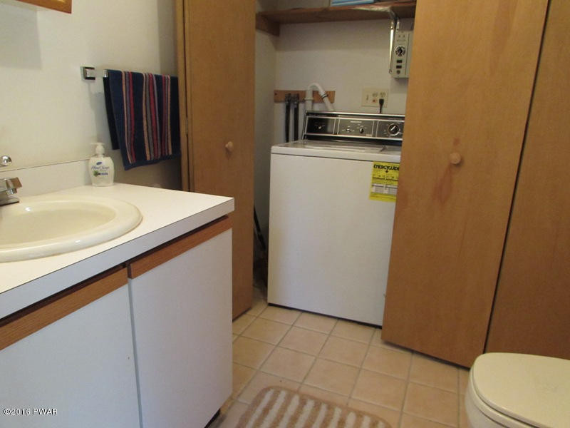 125 Rodeo Lane Hawley, PA 18428 - Photo 22 of 43 a bathroom with a sink a toilet and a mirror