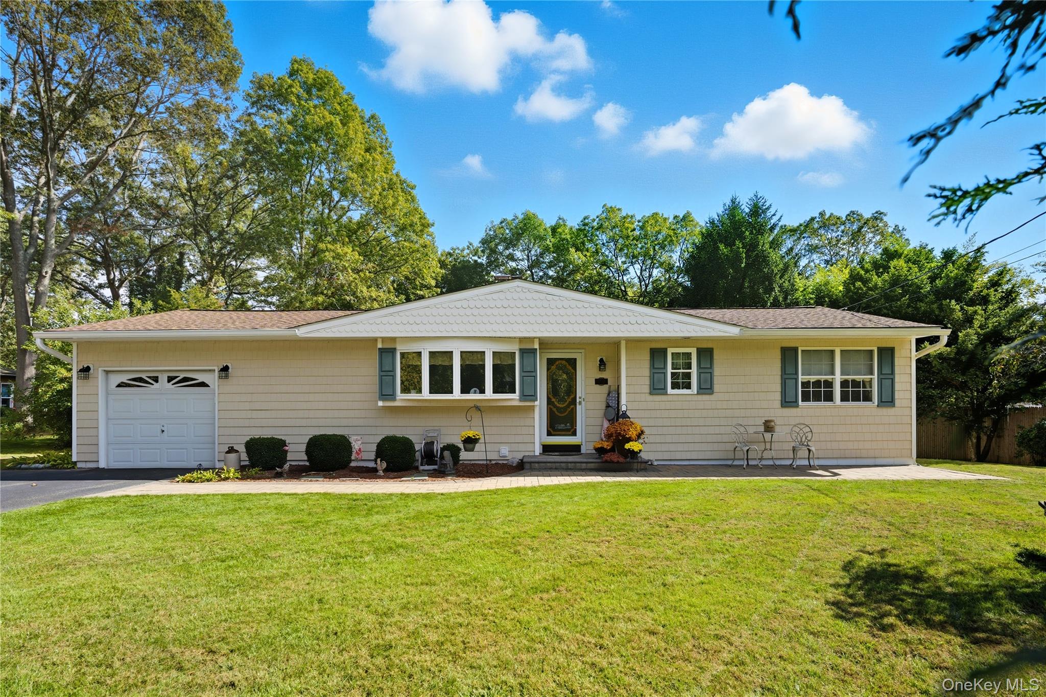 347 Wading River Road Manorville, NY 11949 - Photo 1 of 30 Single story home featuring a front yard, an attached garage, asphalt driveway, and a shingled roof