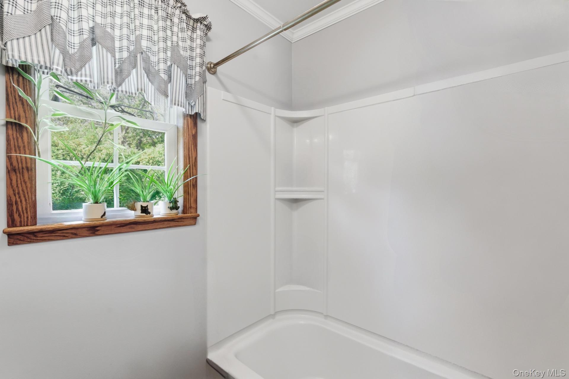 347 Wading River Road Manorville, NY 11949 - Photo 13 of 30 Bathroom with shower / tub combination and crown molding