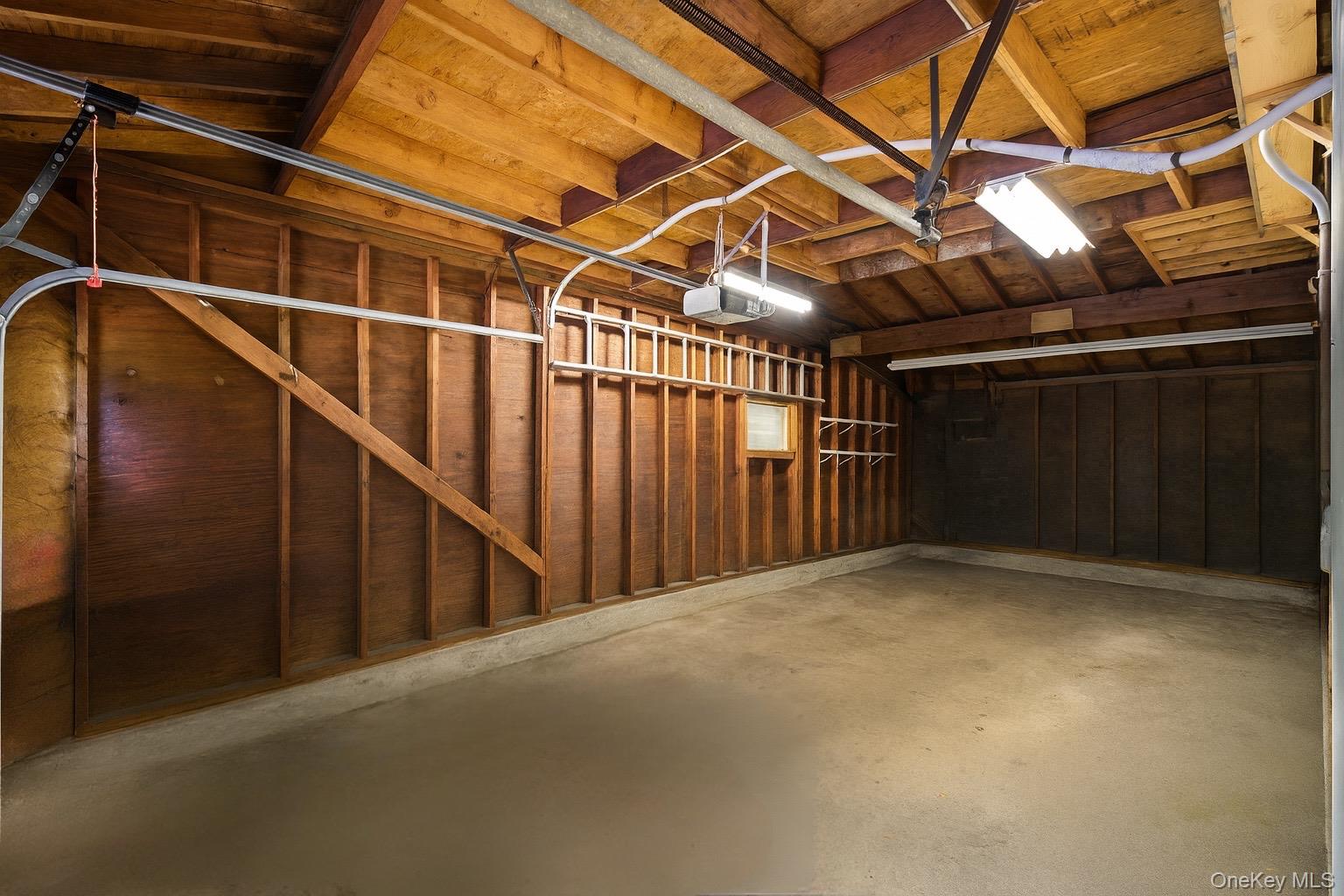 347 Wading River Road Manorville, NY 11949 - Photo 20 of 30 Garage featuring a garage door opener