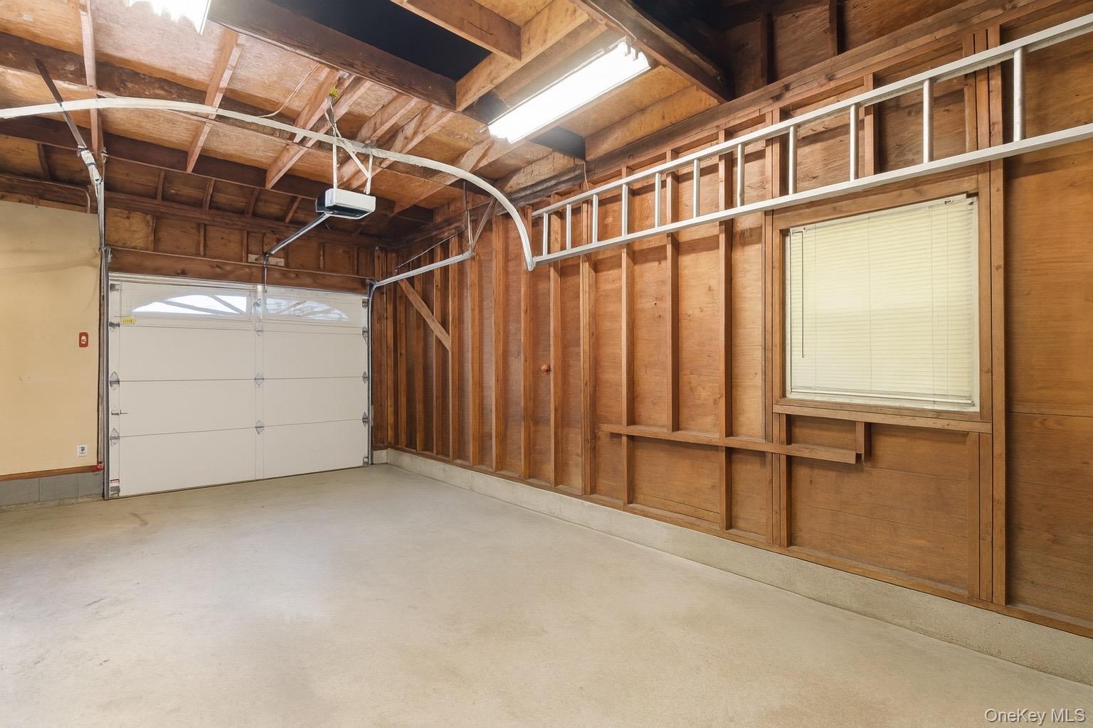 347 Wading River Road Manorville, NY 11949 - Photo 21 of 30 Garage with a garage door opener