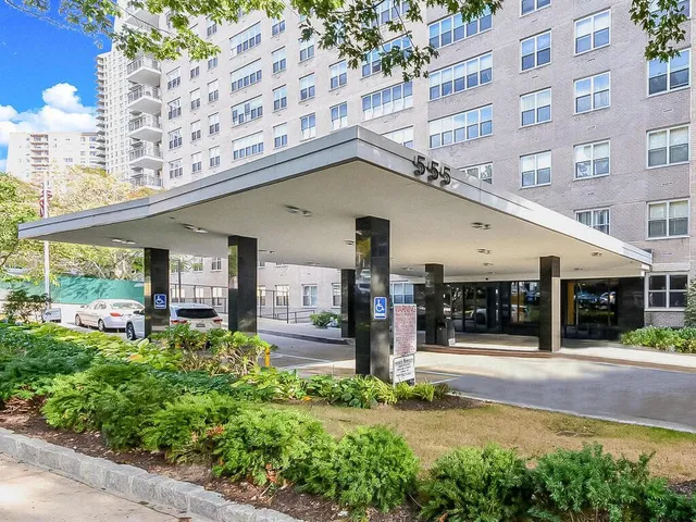 a front view of a building with a garden