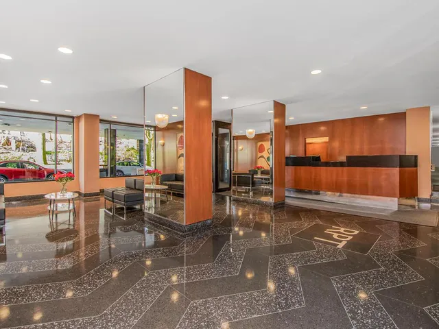 a view of a floor to room with kitchen island dining table and chairs