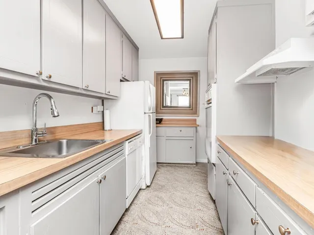 a kitchen with a sink and cabinets