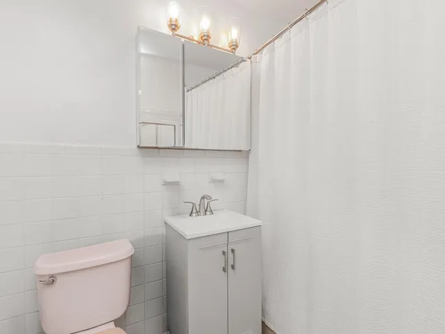 a bathroom with a sink a toilet and vanity