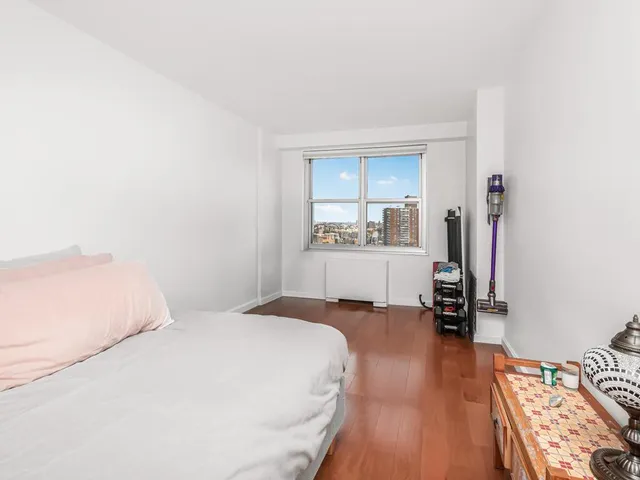 a bedroom with a bed and a view of kitchen