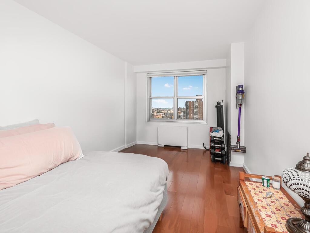 555 Kappock Street, Unit 18C Bronx, NY 10463 - Photo 10 of 19 a bedroom with a bed and a view of kitchen